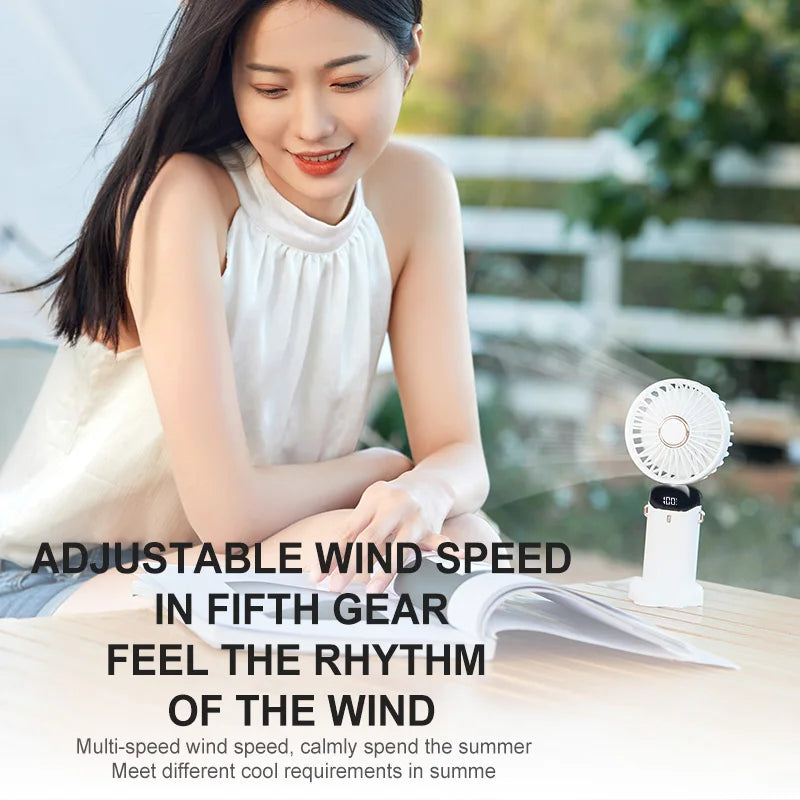 Woman reading a book with a small white fan on a table, promotional text about fan features.